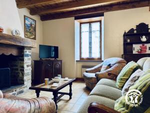 a living room with two couches and a fireplace at Le gîte de cals haut in Lacombe