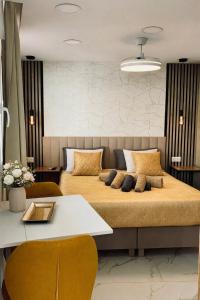 a bedroom with two beds and a white table at Las Americas Prime Suite Spot in Costa de Adeje