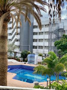 a swimming pool in front of a large building at Las Americas Prime Suite Spot in Costa de Adeje