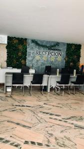 a group of tables and chairs in a room at Las Americas Prime Suite Spot in Costa de Adeje