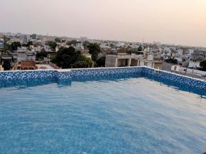 a large swimming pool with a view of a city at Vardaan Residency Hotel in Gorakhpur