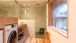 a washing machine in a bathroom with a window at Nuu Takedamise, the Villa in Kami-yuge