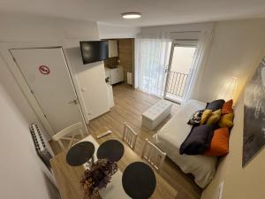 a view of a living room with a table and a couch at Apartamento Room Laredo in Laredo