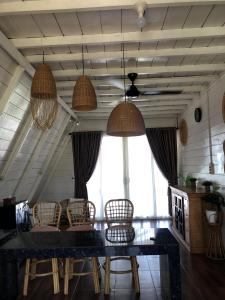 a dining room with a table and chairs at The Kaluna Resort in Lamno