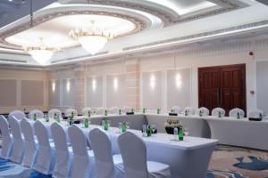 a meeting room with white chairs and a long table in the middle at Warwick Hotel Al Safa - Jeddah in Jeddah +46 photos