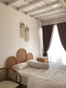a bedroom with a bed and a large window at The Kaluna Resort in Lamno +51 photos