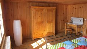 a room with a wooden cabin with a desk and a table at Ferienwohnung Graubünden/ Castiel in Castiel