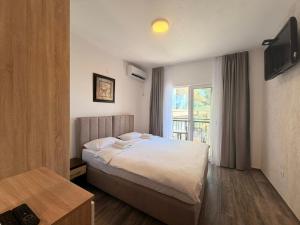 a hotel room with a bed and a window at Beachfront Hotel Palma - Jaz in Budva