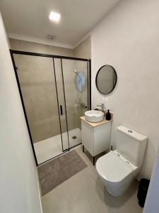 a bathroom with a shower and a toilet and a sink at VillageStay in Rabat