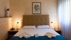 a bedroom with a bed with towels on it at Hotel Lombardia in Milan +130 photos