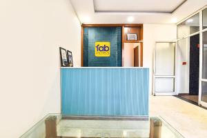 a blue wall in a hallway with a job sign on it at FabHotel Madhuban in Jaipur