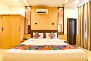 a bedroom with a large bed with wooden walls at FabHotel Madhuban in Jaipur +29 photos