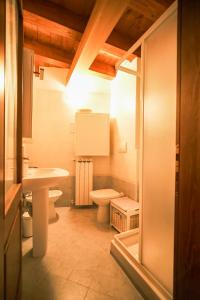 a bathroom with a toilet and a sink at Casa Valerija in Aurisina +13 photos