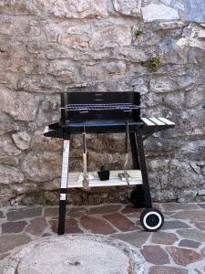 a keyboard on a stand in front of a stone wall at Casa Valerija in Aurisina