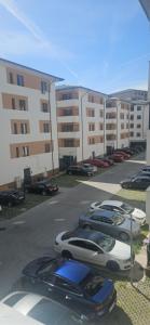 a row of parked cars in a parking lot at Ysa home in Râmnicu Vâlcea