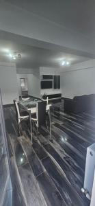 a large living room with a table and chairs at Ysa home in Râmnicu Vâlcea