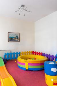 a childs play room with a play table and a playground at Hotel Diplomatic - Bianchi Hotels in Cesenatico