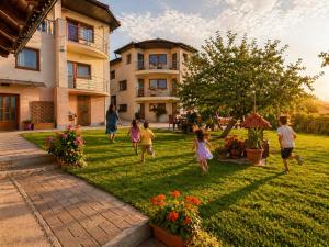 a group of children playing in the yard of a house at NATURA Garden in Cluj-Napoca
