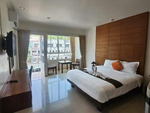 a bedroom with a large bed and a balcony at SR Phuket in Patong Beach +12 photos