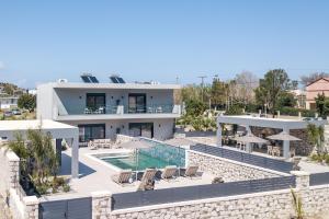 an aerial view of a villa with a swimming pool at Calma Luxury Villas in Kolymbia