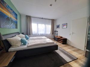 a bedroom with a bed and a large window at Ferienwohnung Zürcher in Chieming