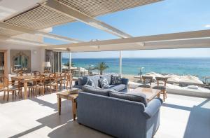 a living room with a view of the ocean at La Mer Escape in Nikiti