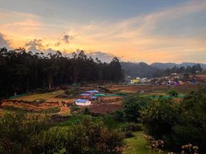 a group of tents in a field at sunset at The Storyhouse in Kūkkāl