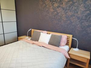 a bedroom with a bed with pillows and a wallpaper at New apartment Eva in Jicin, 2 bedrooms and balcony, Czech Paradise in Jičín +33 photos