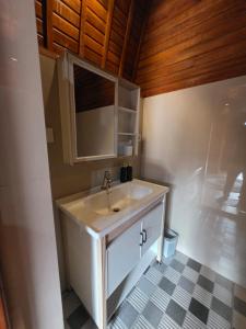 a bathroom with a sink and a mirror at My Lodge Bedugul in Bedugul