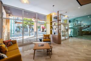 a lobby with a couch and chairs and a table at Résidence Pierre & Vacances Les Citronniers in Menton +49 photos
