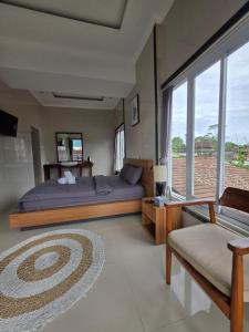 a bedroom with a bed and a large window at My Lodge Bedugul in Bedugul +30 photos