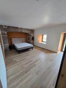 a bedroom with a bed in the middle of a room at Le Ché d'Aubrac in Nasbinals
