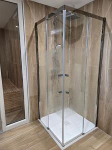 a shower with a glass enclosure in a room at Le Ché d'Aubrac in Nasbinals