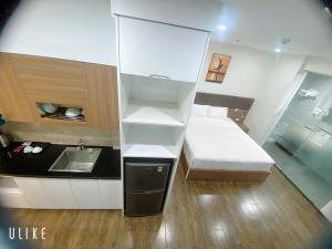a small room with a bed and a sink at Khách sạn QUEENIE in Hai Phong