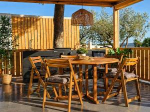 a wooden table and chairs on a patio at Aurea Lux in Pakoštane