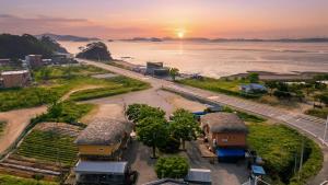 an aerial view of a beach at sunset at Daebudo Banditbul Pension in Ansan