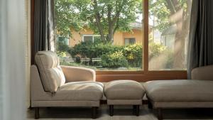 a living room with a chair and a window at Daebudo Banditbul Pension in Ansan +2 photos