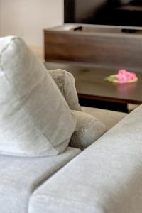 a close up of a bed with pillows and a table at 2-Bed Vialonga Vista Apartment in Lisbon +50 photos