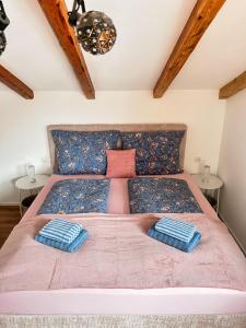 a bedroom with a large bed with two pillows at Haus Friedau in Ellmau