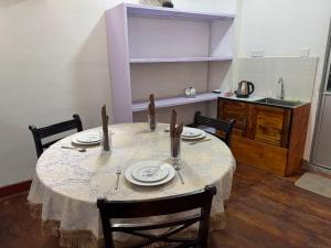 a kitchen with a table with plates and utensils at The Tamarind Villa in Kandy
