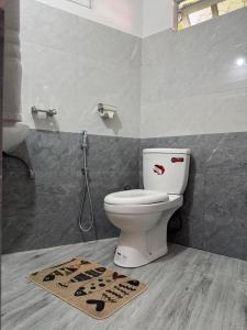 a bathroom with a toilet and a shower at The Tamarind Villa in Kandy