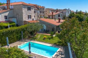 an image of a swimming pool in a yard with houses at Stonehouse Ewa&Pool in Medulin