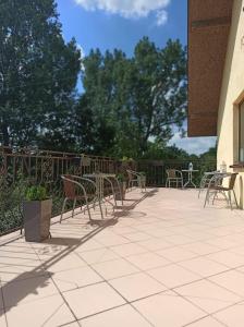 a group of chairs and tables on a patio at Przylesie in Uniejow