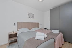 a bedroom with two beds with white pillows on them at House AGAPE near Zagreb with rooftop jacuzzi in Kerestinec