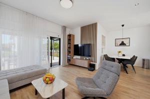 a living room with a couch and a table at House AGAPE near Zagreb with rooftop jacuzzi in Kerestinec