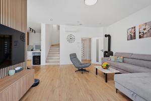 a living room with a couch and a chair at House AGAPE near Zagreb with rooftop jacuzzi in Kerestinec