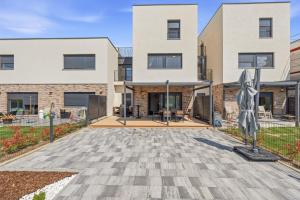 an apartment building with a courtyard in front of it at House AGAPE near Zagreb with rooftop jacuzzi in Kerestinec