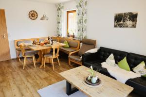 a living room with a couch and a table at Ferienhof Egger in Tettnang
