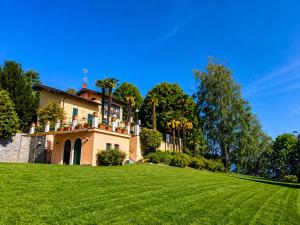 a house on top of a lush green field at Villa Romilda in Arona