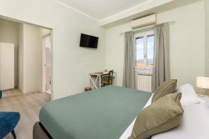 a bedroom with a large bed and a window at B&B Il Connubio - Rooms & Apt between Florence and Chianti in Impruneta